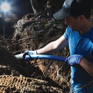Contractor installing insulation on pipe at job site