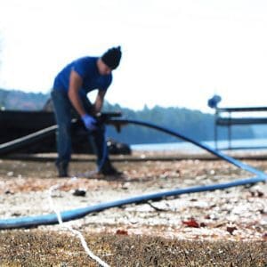 Contractor holding Polyethylene Pipe outdoors near a lake