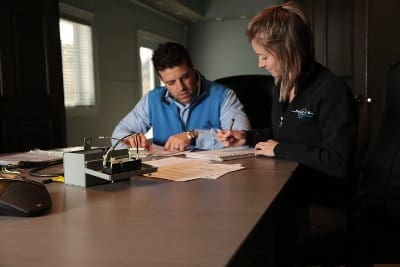 Two workers looking at paper at boardroom table