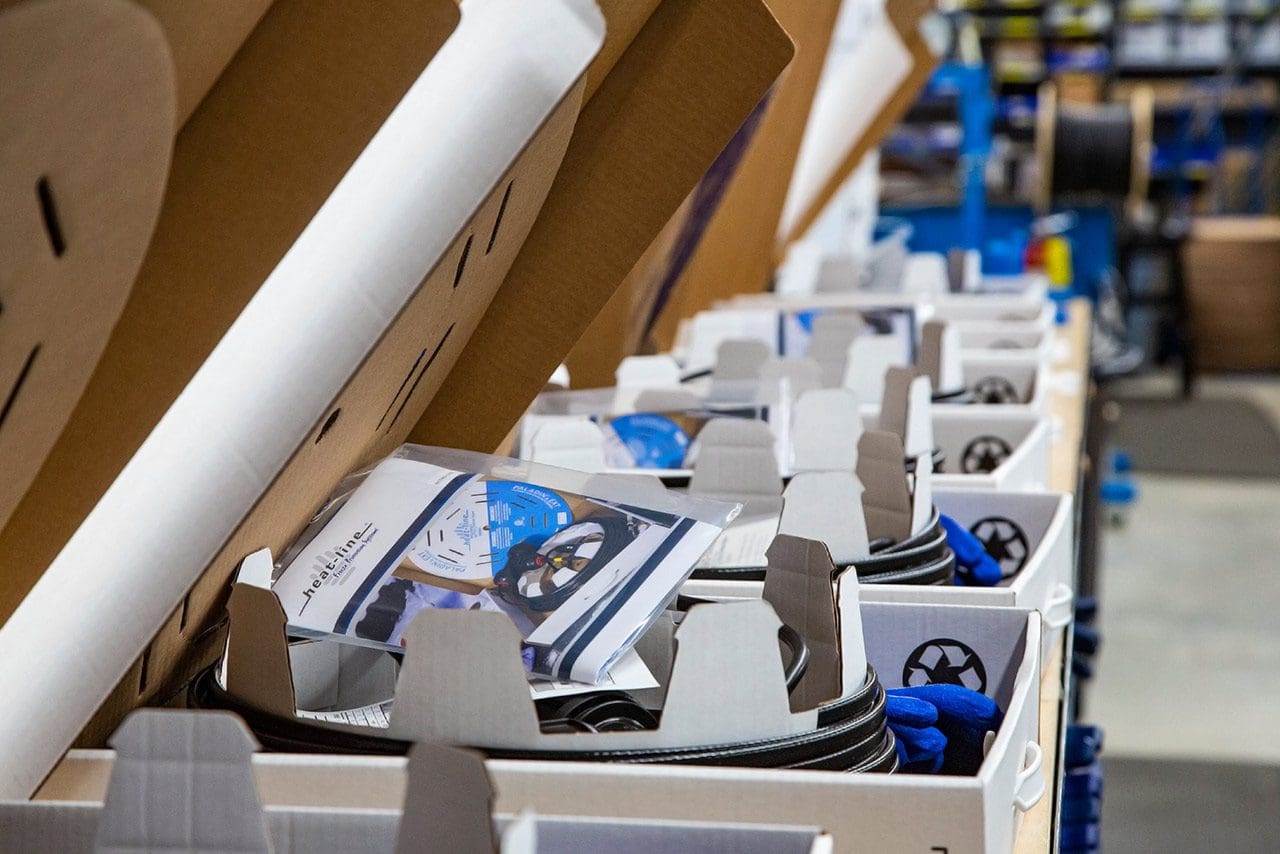 Assembly line of seven Heat-Line products in open boxes